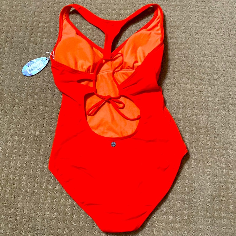 NWT one piece beautifully styled with halter top lined cups back cutout details